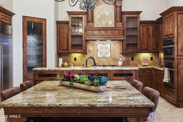 4401 E Taurus Pl, Chandler, AZ 85249 - kitchen with custom range hood, light tile patterned floors, appliances with stainless steel finishes, and light stone counters