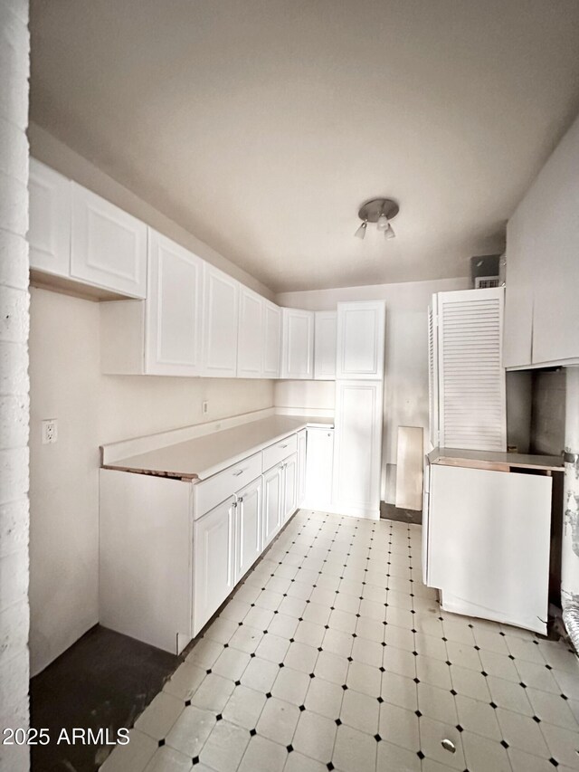 1124 N Villa Nueva Dr, Litchfield Park, AZ 85340 - kitchen featuring white cabinets, light countertops, and light floors