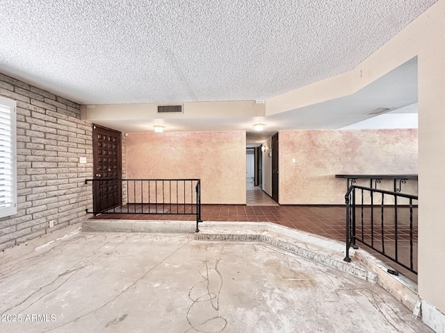 1124 N Villa Nueva Dr, Litchfield Park, AZ 85340 - below grade area with a textured ceiling and brick wall