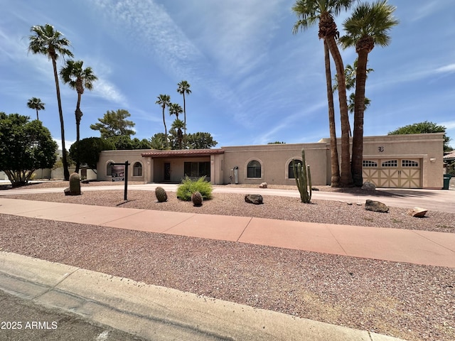 1124 N Villa Nueva Dr, Litchfield Park, AZ 85340 - view of front of home featuring driveway, an attached garage, and stucco siding