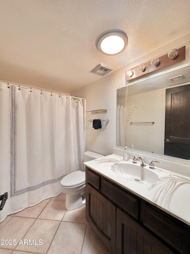 1124 N Villa Nueva Dr, Litchfield Park, AZ 85340 - bathroom featuring vanity, toilet, tile patterned floors, a textured ceiling, and a shower with shower curtain