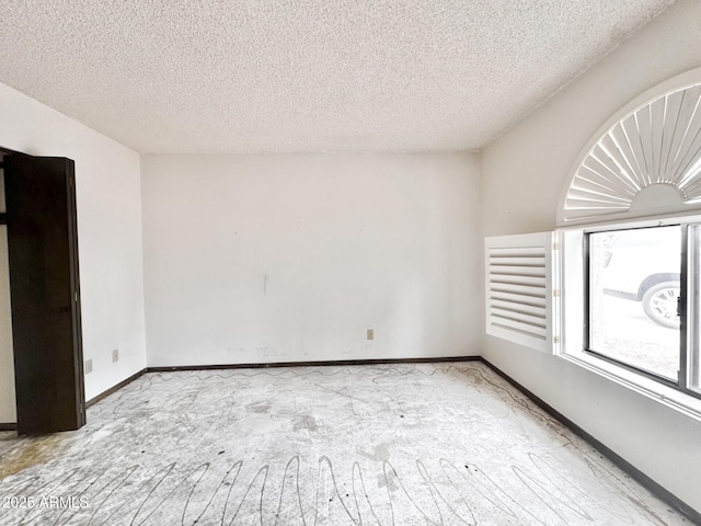 1124 N Villa Nueva Dr, Litchfield Park, AZ 85340 - empty room featuring a textured ceiling and baseboards