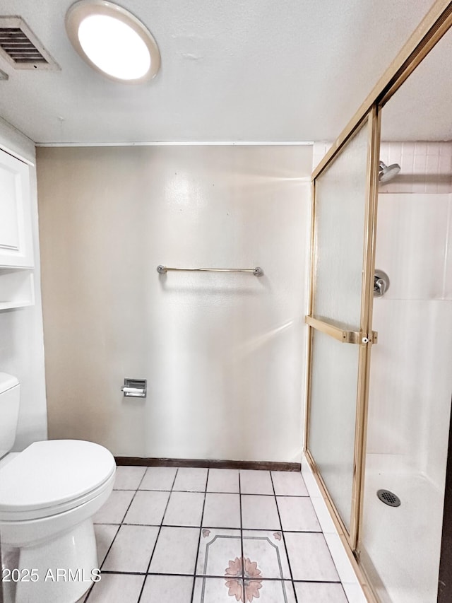 1124 N Villa Nueva Dr, Litchfield Park, AZ 85340 - full bathroom with toilet, a stall shower, tile patterned floors, and baseboards