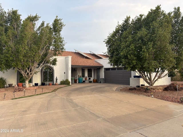 mediterranean / spanish house featuring a garage