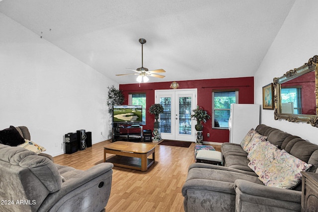 living room with french doors, a textured ceiling, ceiling fan, light hardwood / wood-style floors, and lofted ceiling