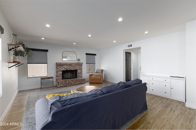 living room featuring a fireplace and light hardwood / wood-style flooring