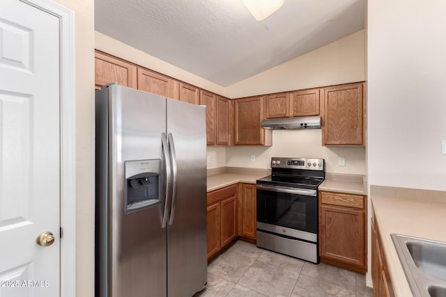 kitchen with under cabinet range hood, appliances with stainless steel finishes, a sink, and light countertops