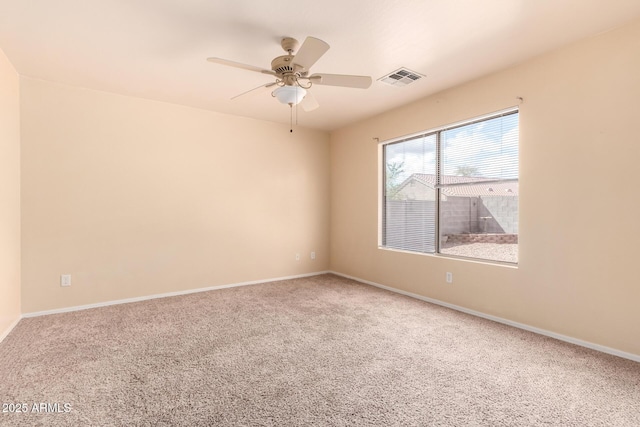 unfurnished room with visible vents, baseboards, carpet, and ceiling fan