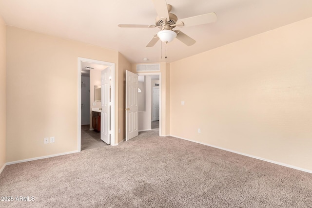 unfurnished bedroom with visible vents, baseboards, light colored carpet, and connected bathroom