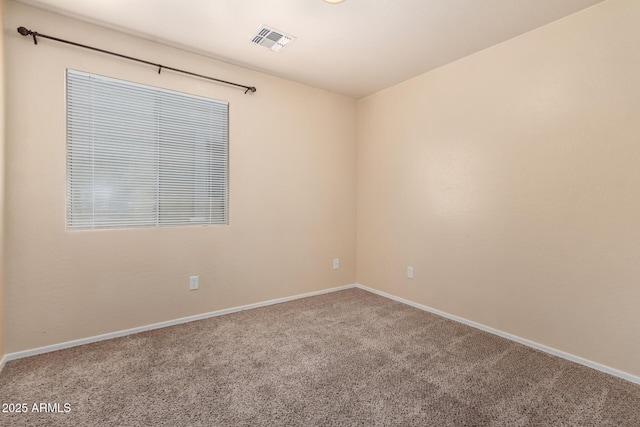 spare room featuring visible vents, carpet floors, and baseboards