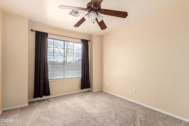 empty room with baseboards, carpet, visible vents, and ceiling fan