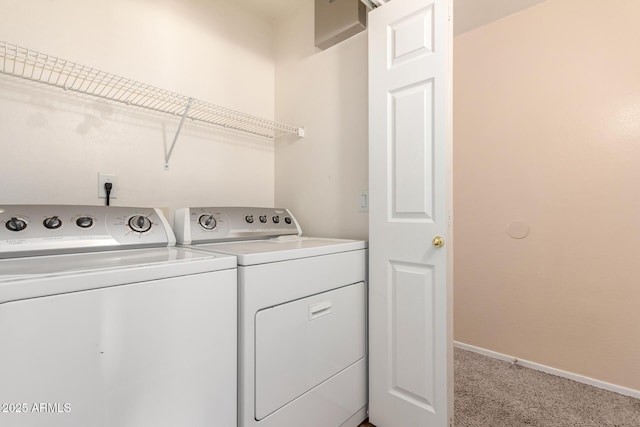 washroom featuring baseboards, light carpet, independent washer and dryer, and laundry area