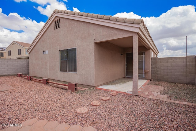 back of property with a patio, a fenced backyard, and stucco siding