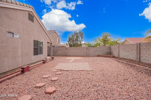 view of yard with a patio and a fenced backyard