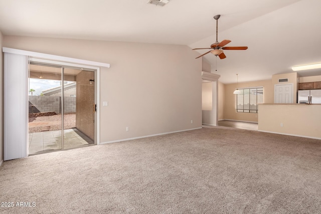 unfurnished living room featuring ceiling fan, baseboards, lofted ceiling, and carpet