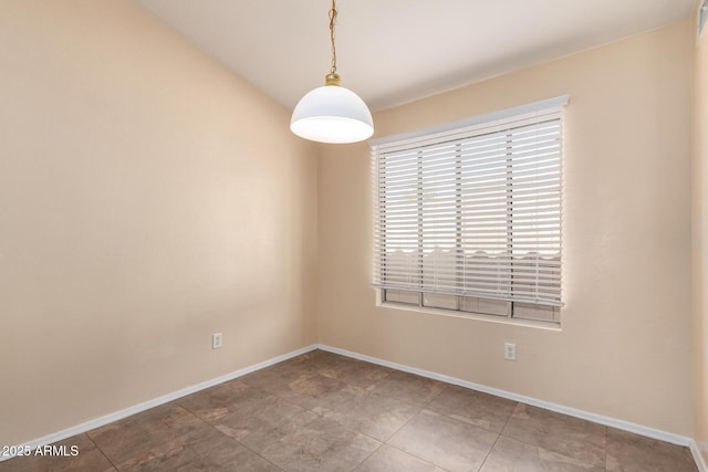 unfurnished room with baseboards