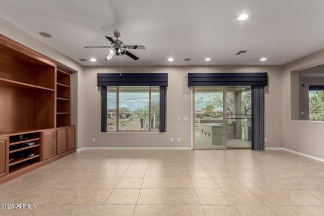 kitchen featuring visible vents, black appliances, a sink, dark stone countertops, and tasteful backsplash