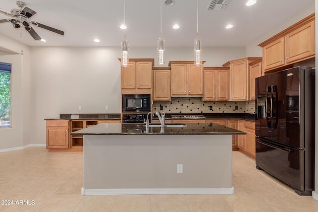 kitchen featuring dark stone countertops, visible vents, a sink, black appliances, and backsplash