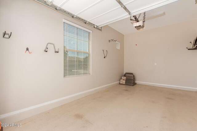 garage with baseboards, a garage door opener, and water heater