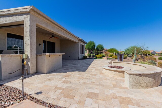 view of patio featuring grilling area, exterior kitchen, and fence