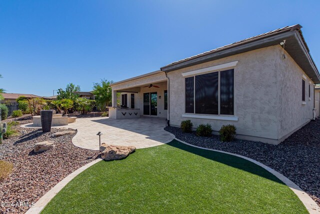 view of patio / terrace featuring area for grilling, a fire pit, and ceiling fan