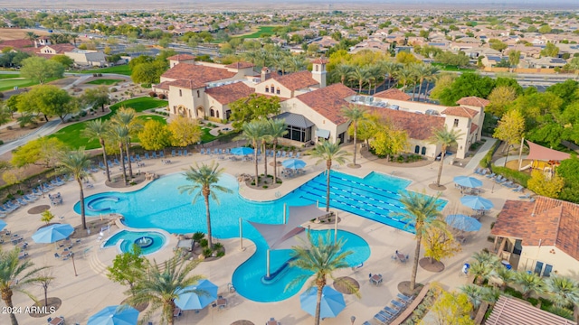 community pool with a residential view and a patio area