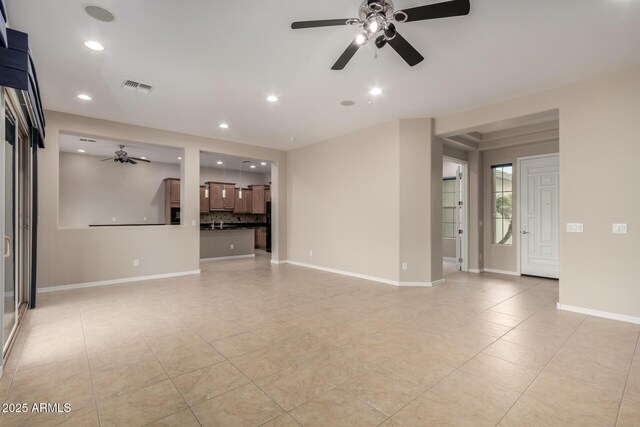 unfurnished living room with a ceiling fan, recessed lighting, visible vents, and baseboards