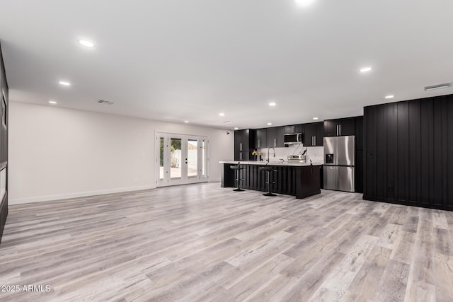 3008 W Michigan Ave, Phoenix, AZ 85053 - kitchen with visible vents, open floor plan, appliances with stainless steel finishes, and light countertops