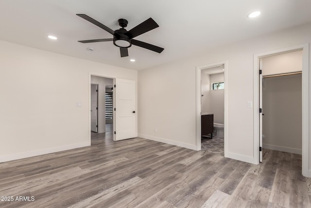 3008 W Michigan Ave, Phoenix, AZ 85053 - unfurnished bedroom with recessed lighting, a spacious closet, wood finished floors, and ensuite bathroom