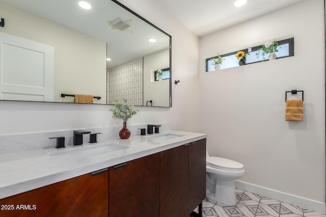 3008 W Michigan Ave, Phoenix, AZ 85053 - full bathroom featuring recessed lighting, a sink, double vanity, and toilet
