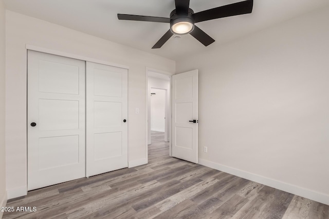 3008 W Michigan Ave, Phoenix, AZ 85053 - unfurnished bedroom with a closet, baseboards, ceiling fan, and wood finished floors