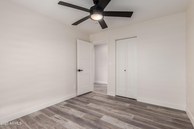 3008 W Michigan Ave, Phoenix, AZ 85053 - unfurnished bedroom featuring baseboards, ceiling fan, wood finished floors, and a closet