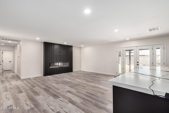 3008 W Michigan Ave, Phoenix, AZ 85053 - unfurnished living room with visible vents, recessed lighting, and a glass covered fireplace