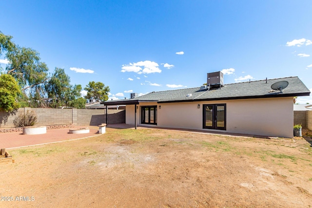 3008 W Michigan Ave, Phoenix, AZ 85053 - rear view of property featuring central AC, a patio, a fenced backyard, roof with shingles, and french doors