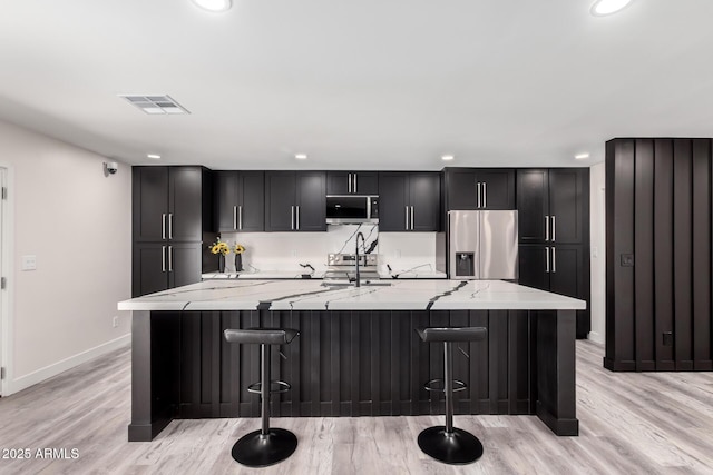 3008 W Michigan Ave, Phoenix, AZ 85053 - kitchen with visible vents, baseboards, a spacious island, recessed lighting, and stainless steel appliances