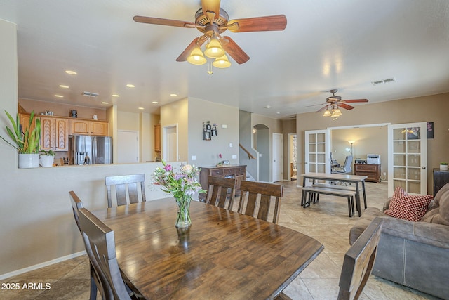 26842 N 176th Ln, Surprise, AZ 85387 - dining space with arched walkways, light tile patterned floors, a ceiling fan, and visible vents