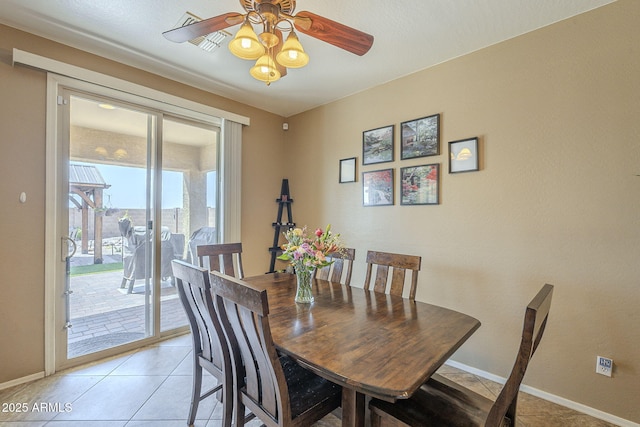 26842 N 176th Ln, Surprise, AZ 85387 - dining room with light tile patterned flooring, baseboards, and a ceiling fan