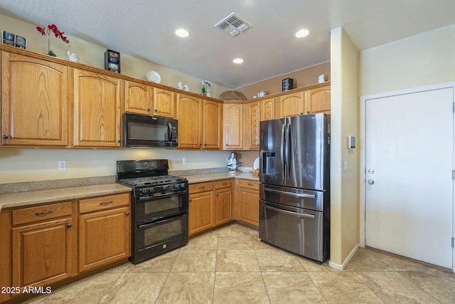 26842 N 176th Ln, Surprise, AZ 85387 - kitchen with light tile patterned flooring, visible vents, light countertops, and black appliances