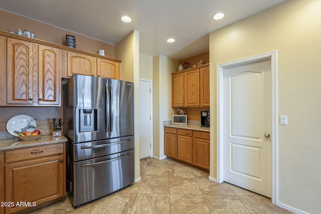 26842 N 176th Ln, Surprise, AZ 85387 - kitchen with stainless steel fridge with ice dispenser, light tile patterned floors, and brown cabinetry