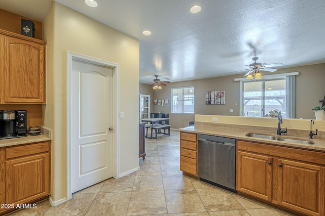 26842 N 176th Ln, Surprise, AZ 85387 - kitchen with ceiling fan, light tile patterned floors, brown cabinetry, dishwasher, and a sink