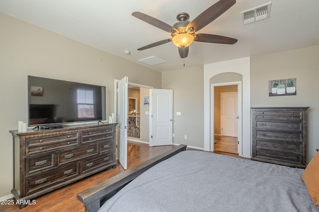 26842 N 176th Ln, Surprise, AZ 85387 - bedroom with arched walkways, wood finished floors, baseboards, and visible vents