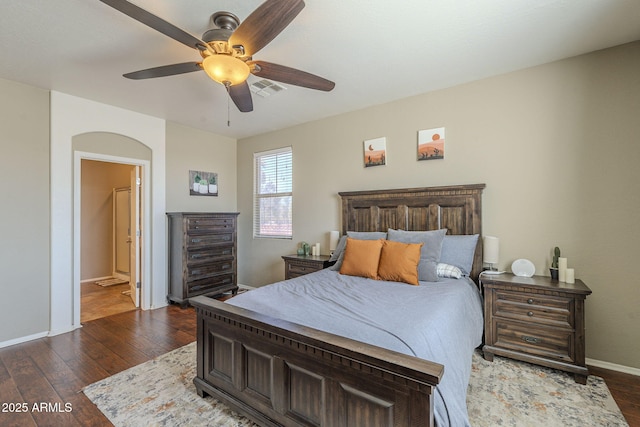 26842 N 176th Ln, Surprise, AZ 85387 - bedroom featuring ensuite bathroom, baseboards, dark wood-style floors, and visible vents