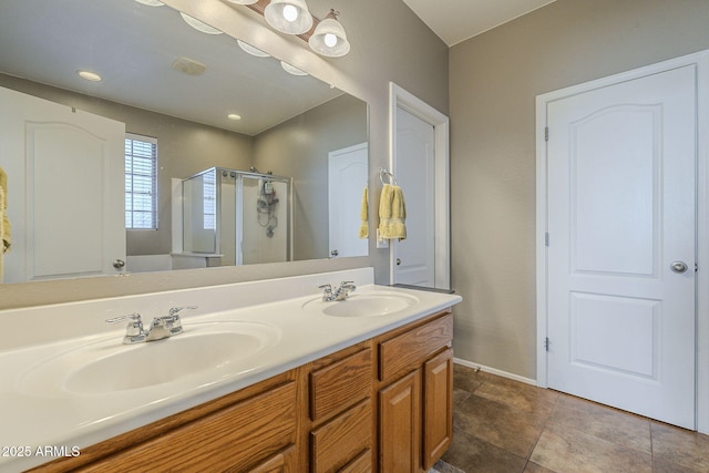 26842 N 176th Ln, Surprise, AZ 85387 - full bathroom featuring a sink, baseboards, a shower stall, and double vanity