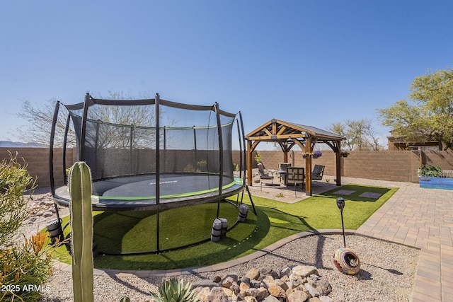 26842 N 176th Ln, Surprise, AZ 85387 - view of play area featuring a yard, a gazebo, a trampoline, a fenced backyard, and a patio