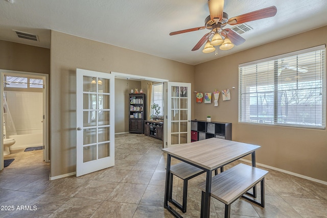 26842 N 176th Ln, Surprise, AZ 85387 - dining space with light tile patterned floors, a ceiling fan, visible vents, french doors, and baseboards