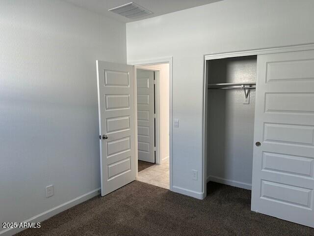 38055 W Excussare Way, Maricopa, AZ 85138 - unfurnished bedroom featuring carpet flooring, a closet, and baseboards