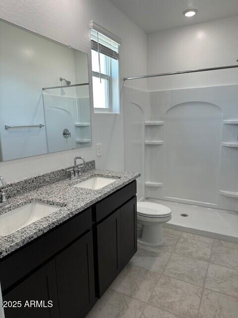 38055 W Excussare Way, Maricopa, AZ 85138 - bathroom with walk in shower, toilet, and double vanity