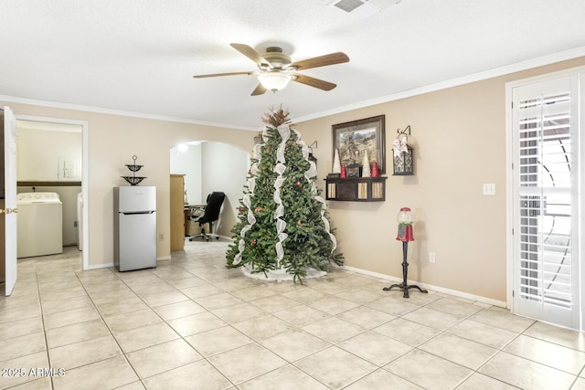 interior space with ceiling fan, washer / clothes dryer, and crown molding