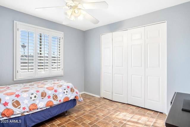 bedroom with ceiling fan and a closet