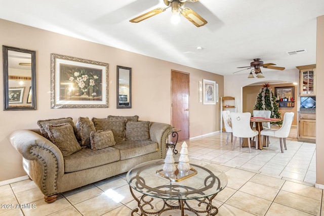 living room with ceiling fan and light tile patterned flooring